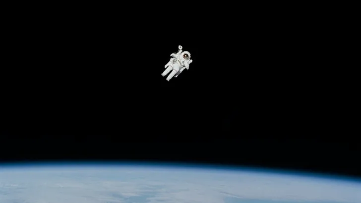 Astronaut floating free over the Earth